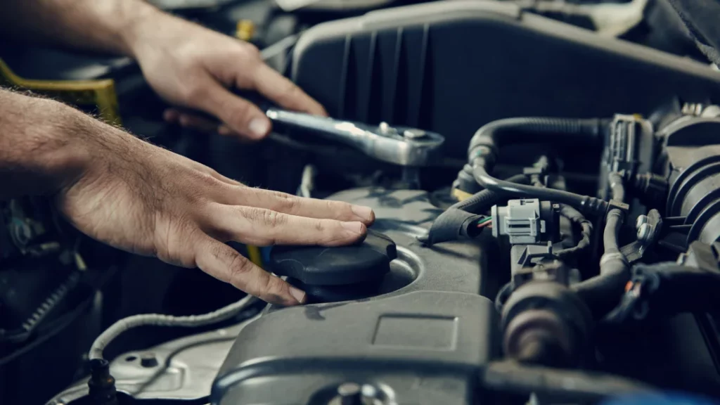 A man repairs a car engine, demonstrating skills in general mechanics and automotive maintenance.